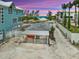 Coastal home showcasing a carport and beach access with stunning sunset hues at 616 S Casey Key Rd, Nokomis, FL 34275