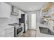 Bright white kitchen with modern appliances, subway tile backsplash, and stylish accents at 616 S Casey Key Rd, Nokomis, FL 34275