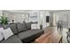 Open-concept living space with modern sofa, bar area, and stylish design at 616 S Casey Key Rd, Nokomis, FL 34275