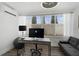 Home office featuring wood floors, a desk, a sofa and an AC unit at 616 S Casey Key Rd, Nokomis, FL 34275