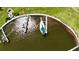 Overhead view of a waterfront area with a sailboat docked near lush green spaces and community amenities at 623 Leisure, Venice, FL 34285