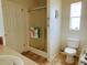 Bathroom with glass shower, toilet, sink, and window with natural light at 623 Leisure, Venice, FL 34285