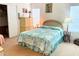 Comfortable bedroom featuring a bed, window with blinds, dresser, and charming decor at 623 Leisure, Venice, FL 34285