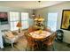 Cozy dining area featuring natural light and a classic wooden dining set at 623 Leisure, Venice, FL 34285