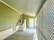 Covered walkway of home with white stairs and railings leading to the entrance at 623 Leisure, Venice, FL 34285