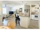 This open-concept living space showcases bar seating, a modern kitchen, and a cozy living room at 623 Leisure, Venice, FL 34285
