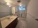 Bathroom featuring vanity sink with drawers, a toilet, and a shower-tub with a glass door at 624 White Pine Tree Rd # 5, Venice, FL 34285