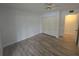 Bright, neutral bedroom featuring wood-look flooring, closet, and ensuite entry at 624 White Pine Tree Rd # 5, Venice, FL 34285