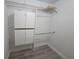Walk in closet featuring lots of storage and organization potential with shelves, cabinets and bars at 624 White Pine Tree Rd # 5, Venice, FL 34285