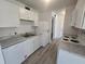 Kitchen with appliances, white cabinets, gray counters, and a view of the rest of the home at 624 White Pine Tree Rd # 5, Venice, FL 34285