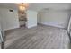 A wide shot of the living room showing the open concept to the kitchen and the bright, new floors at 624 White Pine Tree Rd # 5, Venice, FL 34285