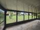 Screened patio with a view of the green space and mature trees at 624 White Pine Tree Rd # 5, Venice, FL 34285
