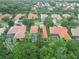 Expansive aerial view of homes with tile roofs, lush greenery, and mature trees at 6619 Pinefeather Ct, Bradenton, FL 34203