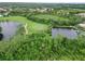 Scenic aerial shot of the golf course, ponds, and lush surroundings at 6619 Pinefeather Ct, Bradenton, FL 34203