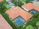 Unique aerial view of a property showcasing a tiled roof and screened-in swimming pool at 6619 Pinefeather Ct, Bradenton, FL 34203