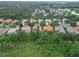An aerial view showcases homes with tile roofs nestled amidst lush green landscaping at 6619 Pinefeather Ct, Bradenton, FL 34203