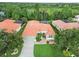 Expansive aerial shot showcasing the home's landscaping, green lawn, screened-in pool, and well-maintained surroundings at 6619 Pinefeather Ct, Bradenton, FL 34203