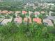 Elevated community shot showing homes with terracotta roofs, wooded areas, and lush lawns at 6619 Pinefeather Ct, Bradenton, FL 34203