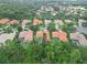 Overhead community shot with homes featuring tiled roofs, mature trees, and lush lawns at 6619 Pinefeather Ct, Bradenton, FL 34203