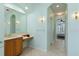 Bathroom with a vanity, tile floor, and arched doorway leading to the bedroom, creating a serene atmosphere at 6619 Pinefeather Ct, Bradenton, FL 34203