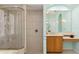 Bright bathroom showcases a glass enclosed shower, large mirror, and vanity with ample counter space at 6619 Pinefeather Ct, Bradenton, FL 34203