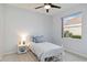 Bright bedroom features a ceiling fan and a window providing natural light at 6619 Pinefeather Ct, Bradenton, FL 34203