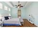 Bright bedroom features tray ceilings, ceiling fan, and wood floors at 6619 Pinefeather Ct, Bradenton, FL 34203