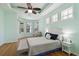 Bright bedroom features tray ceilings, ceiling fan, and wood floors at 6619 Pinefeather Ct, Bradenton, FL 34203