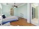 Bright bedroom features tray ceilings, ceiling fan, and wood floors at 6619 Pinefeather Ct, Bradenton, FL 34203