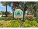 Community entrance sign surrounded by colorful plants and manicured shrubs at 6619 Pinefeather Ct, Bradenton, FL 34203