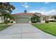 A single Gathering home displays a tile roof, 2 car garage, a pristine lawn, and mature landscaping at 6619 Pinefeather Ct, Bradenton, FL 34203