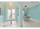 A charming foyer that leads to a dining room with white chairs at 6619 Pinefeather Ct, Bradenton, FL 34203