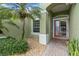 Inviting front entrance with a decorative glass door, lush landscaping, and a neutral green exterior at 6619 Pinefeather Ct, Bradenton, FL 34203