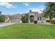 Beautiful single-story home featuring a tile roof, manicured lawn, and inviting front entrance at 6619 Pinefeather Ct, Bradenton, FL 34203