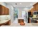 Bright eat-in kitchen boasts wooden cabinets, island, and stainless steel appliances at 6619 Pinefeather Ct, Bradenton, FL 34203