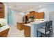 Well-lit kitchen featuring an island with seating and stainless steel appliances at 6619 Pinefeather Ct, Bradenton, FL 34203