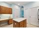 Bright eat-in kitchen boasts wooden cabinets, island, and breakfast nook desk area at 6619 Pinefeather Ct, Bradenton, FL 34203