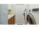 Spacious laundry room with sink, cabinets, and modern washer and dryer at 6619 Pinefeather Ct, Bradenton, FL 34203