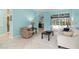 Bright living room with tile floors, neutral furnishings, and access to the outdoor screened-in pool at 6619 Pinefeather Ct, Bradenton, FL 34203