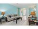 Bright living room with tile floors, and neutral furnishings, creating a welcoming atmosphere at 6619 Pinefeather Ct, Bradenton, FL 34203