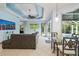 Open-concept living room and dining area with tile floors and abundant natural light overlooking the pool at 6619 Pinefeather Ct, Bradenton, FL 34203
