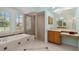 Main bathroom featuring a separate shower and bathtub, a vanity with sink, and natural light at 6619 Pinefeather Ct, Bradenton, FL 34203