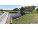 Picturesque pond view featuring a fountain, lush greenery, and a charming walking bridge, offering a peaceful retreat at 6619 Pinefeather Ct, Bradenton, FL 34203