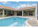 A stunning screened-in pool with clear water and a unique compass design on the bottom at 6619 Pinefeather Ct, Bradenton, FL 34203