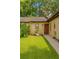 Inviting single-story home with a well-manicured lawn and charming front door entrance at 7201 Daiquiri Ln, Tampa, FL 33634