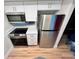 Compact kitchen with stainless steel appliances and modern white cabinets at 7201 Daiquiri Ln, Tampa, FL 33634