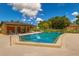 Community pool with plenty of seating, lounge chairs and a large pool surrounded by a concrete deck at 7201 Daiquiri Ln, Tampa, FL 33634