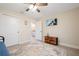 Comfortable bedroom with coastal decor, a ceiling fan, and an ensuite bathroom at 7257 Maguire Ln, Englewood, FL 34224