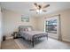 Relaxing bedroom with neutral tones, a wrought iron bed frame, and a view of the screened lanai at 7257 Maguire Ln, Englewood, FL 34224