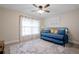 Cozy bedroom with a daybed, ceiling fan, and soft natural light from the window at 7257 Maguire Ln, Englewood, FL 34224